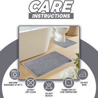OLIVIA ROCCO charcoal ribbed bath mat set with two non-slip, super absorbent, extra soft bath mats on a bathroom floor.